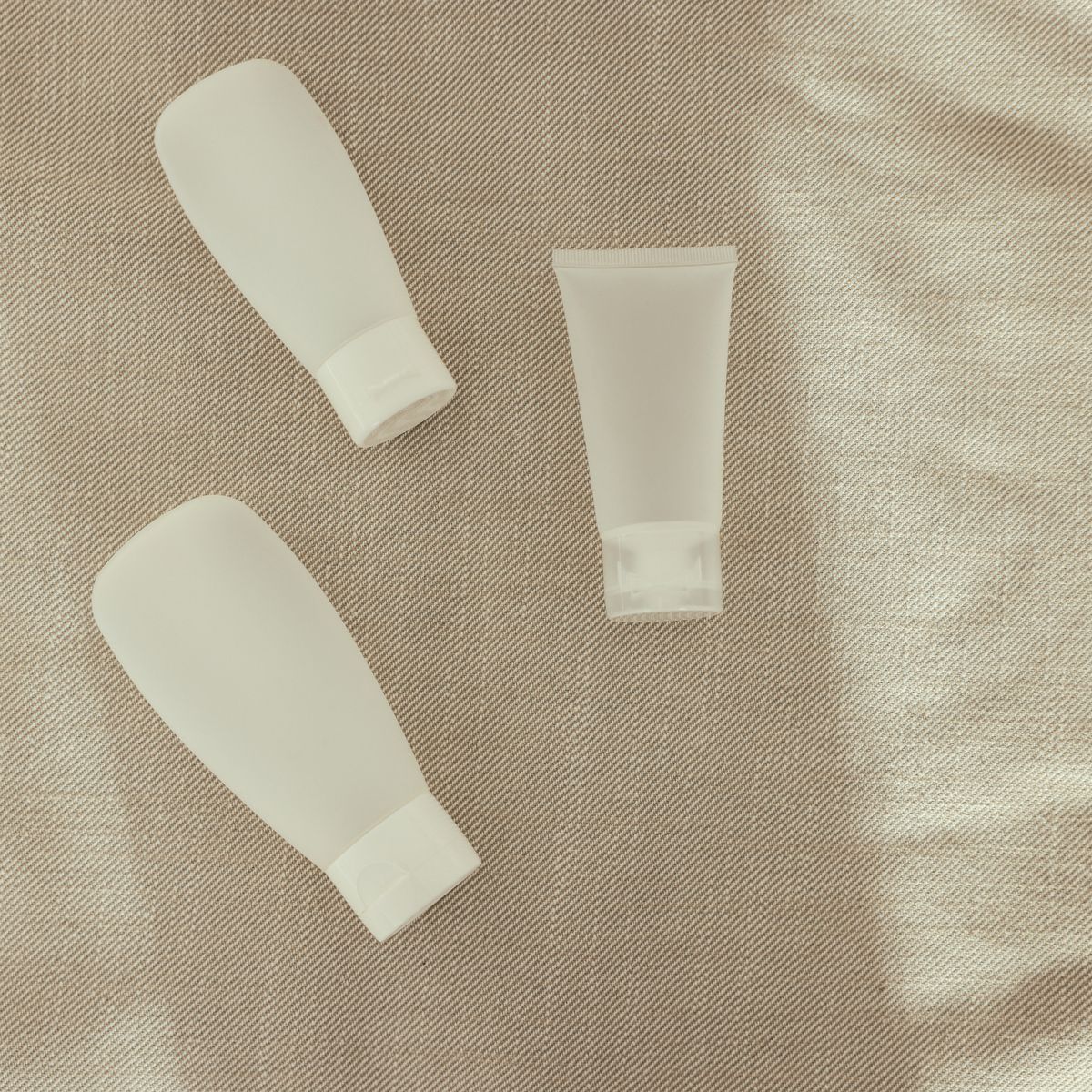 A simple seborrheic dermatitis face routine laid out: gentle cleanser, serum, and moisturizer