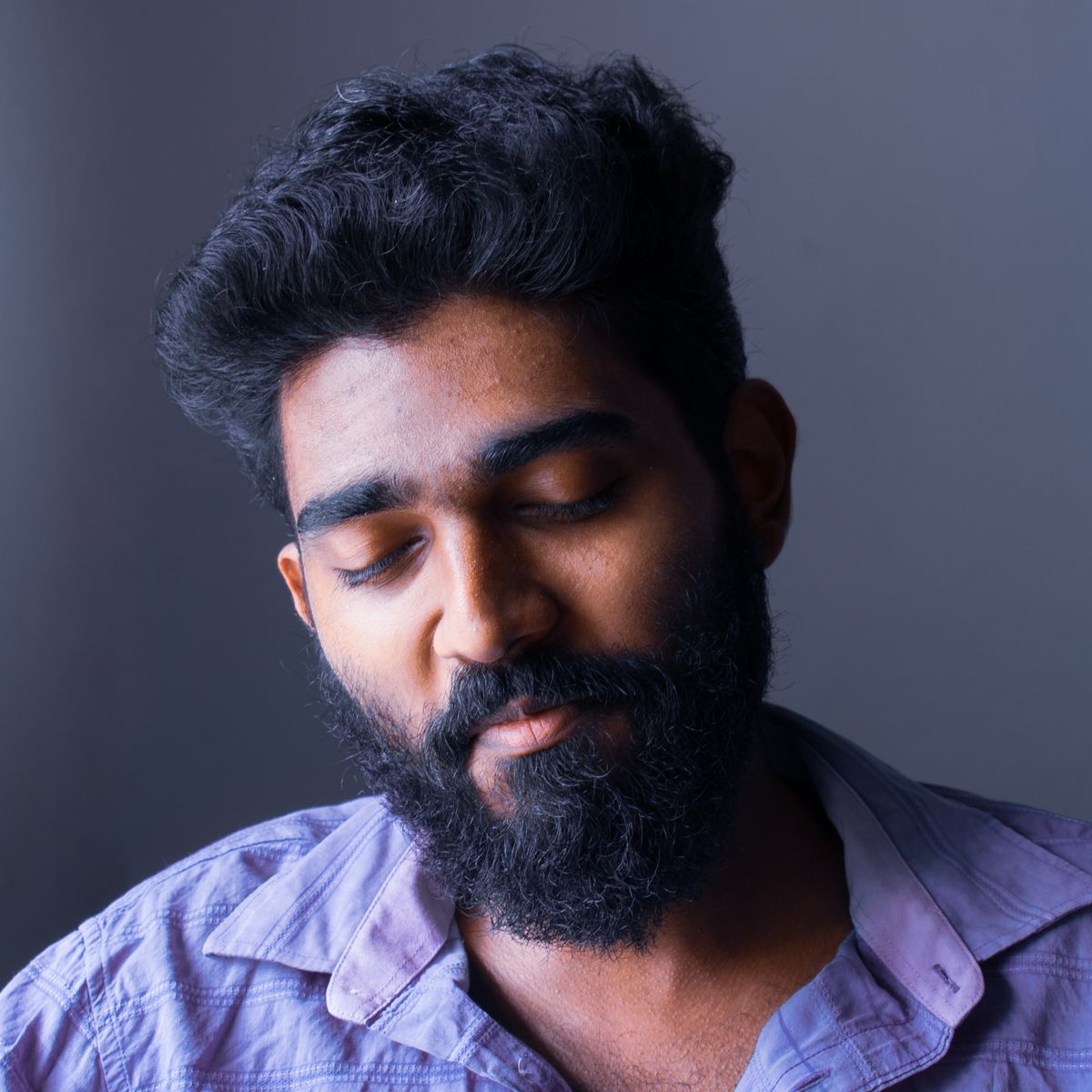 A bearded man choosing a beard oil suitable for seborrheic dermatitis