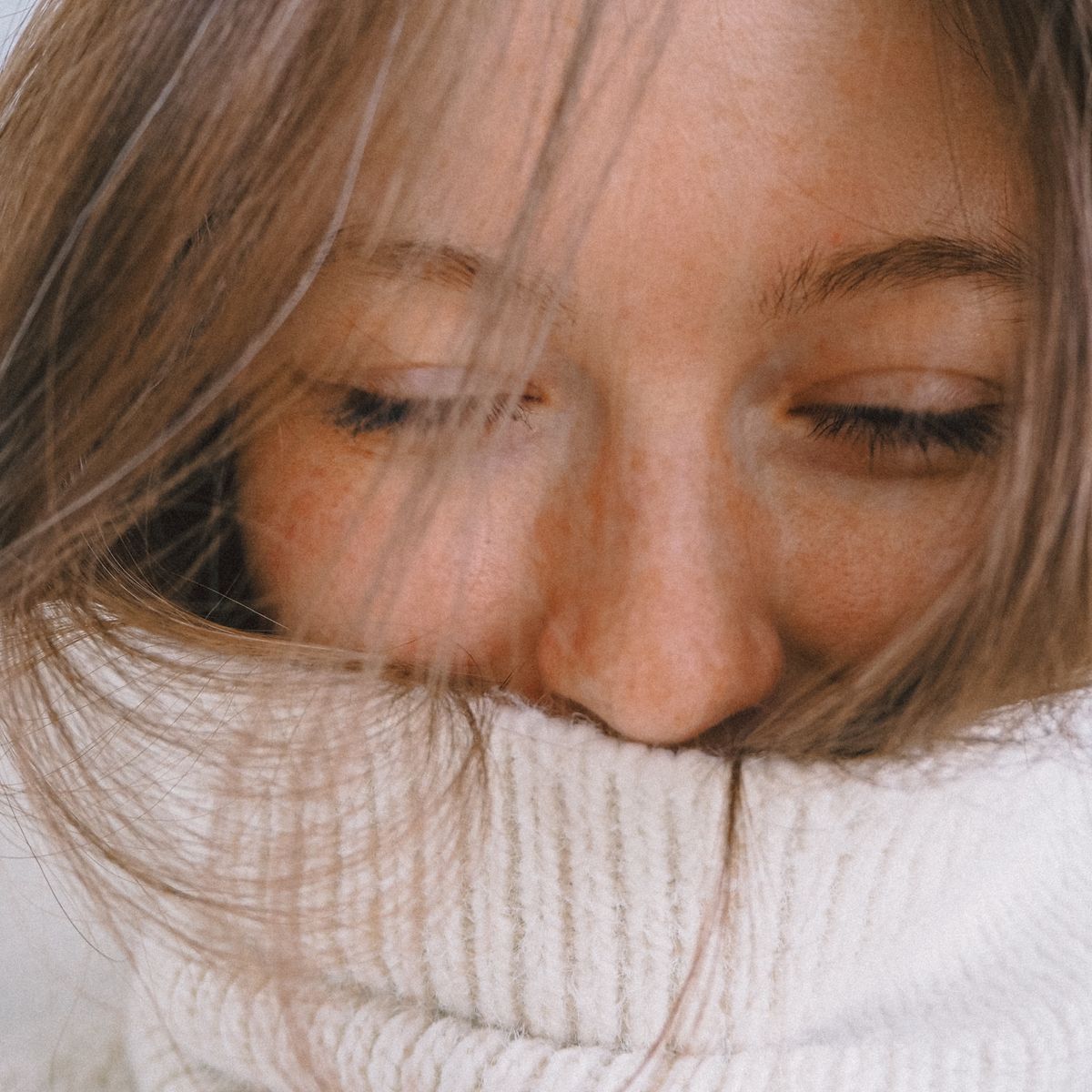 A woman with her eyes gently closed