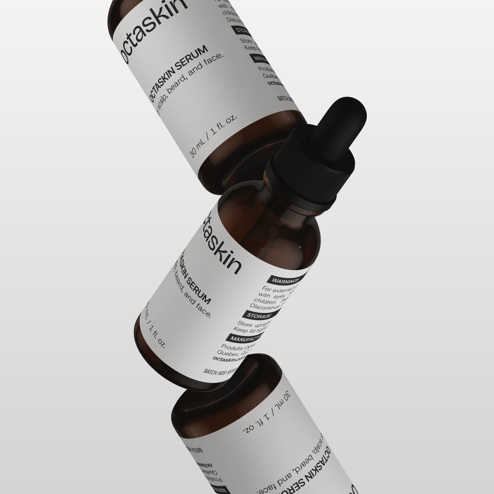 Three bottles of Octaskin's serum with droppers on a light gray background