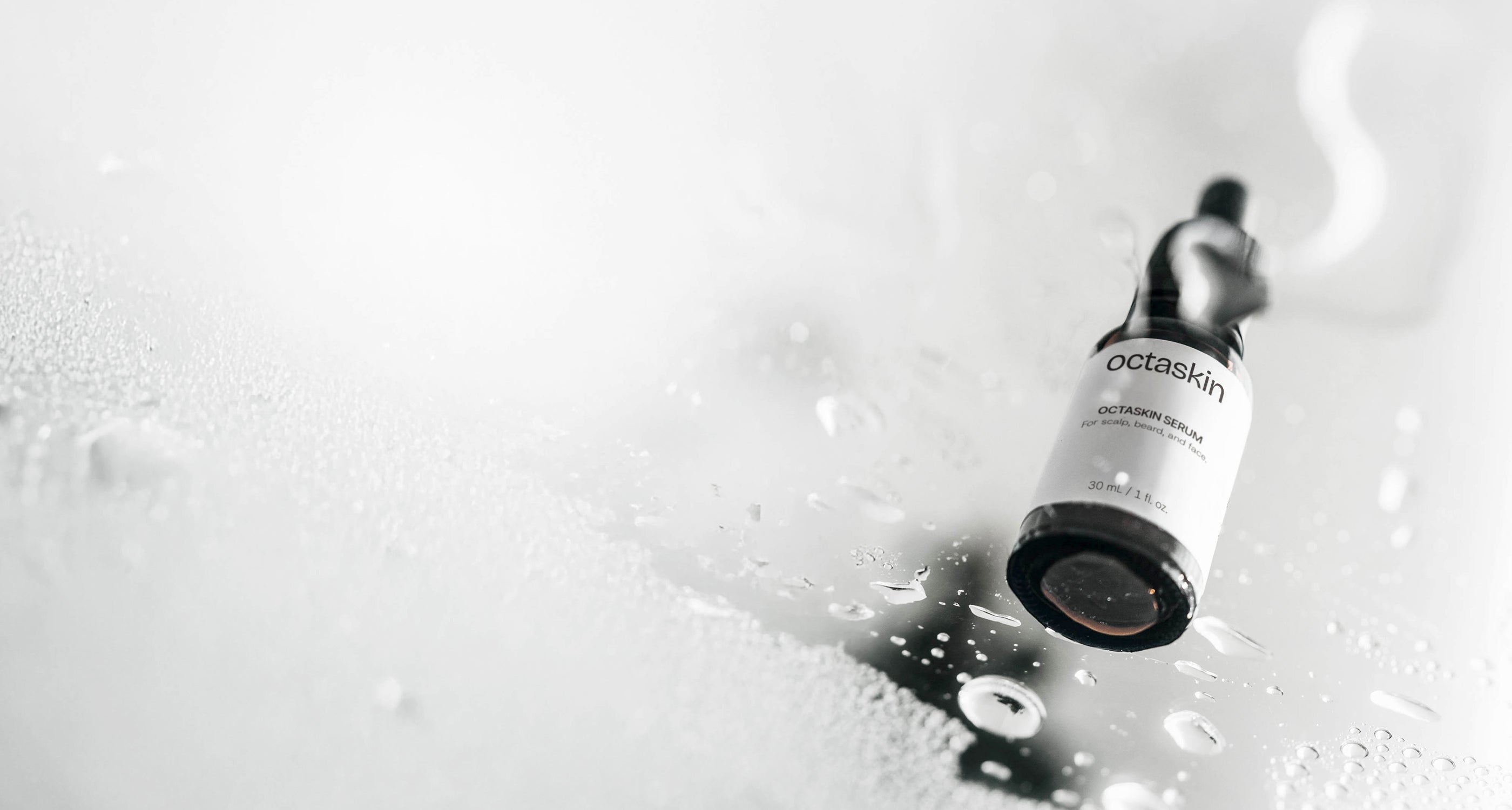 Skincare bottle labeled 'octaskin' on a textured white background