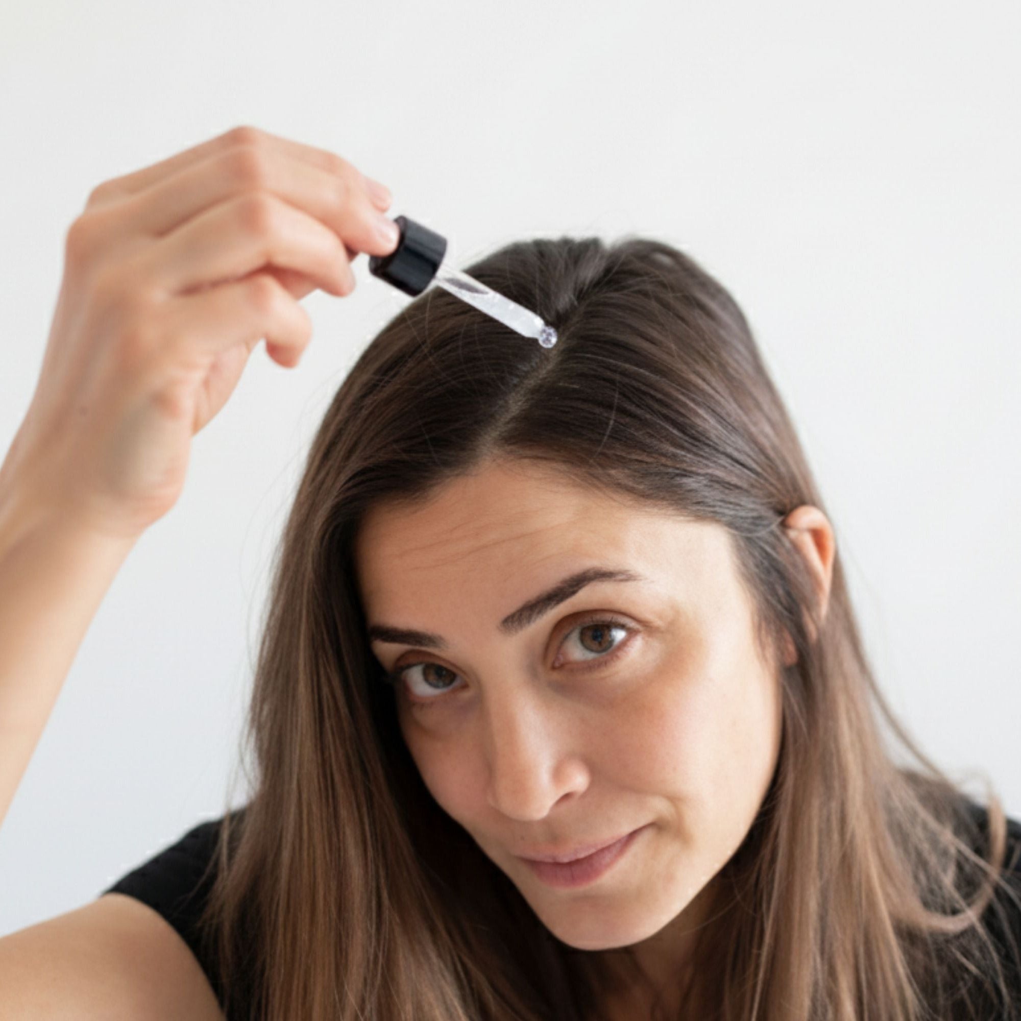 Woman applying octaskin serum
